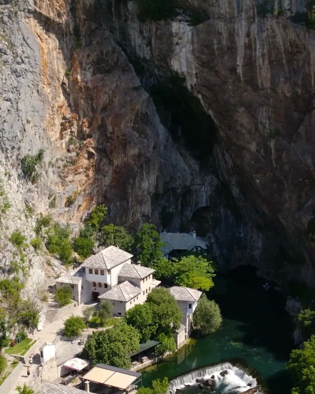 Blagaj Tekke under the cliff, seen from the air